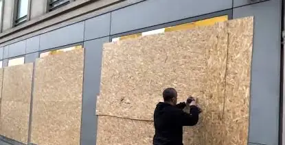 Pose de panneaux de bois pour sécuriser une vitrine après un sinistre